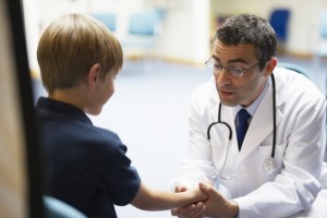 Doctor examining young boy